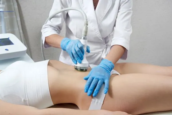 Lost the Weight but Not the Loose Skin? 2 woman having HIFU treatment on her stomach to combat loose skin Warfield following weight loss